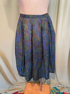 "This is a cute, vintage, 2 piece matching skirt set from early 60s. No labels or tags, appears home sewn It is a skirt and a matching middy top in a cotton blend print of mod flowers & fruit. The fabric is semi sheer. No size tag. Waist measures 26\", bust measures 36\", please see measurements below. The top is a middy top & when worn with the skirt will bare a little of your midriff. It has a fitted band bottom & the rest blouses like a small blouson. The top is semi sheer & i Vintage Blue Full Skirt, Retro Blue Pleated Skirt, Retro Blue Lined Skirt, Blue Retro A-line Skirt, Retro Blue A-line Skirt, Retro Blue Full Skirt, Vintage Pleated Mini Skirt, Vintage Blue Lined Skirt, Blue Lined Vintage Skirt