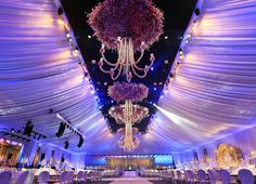 the ceiling is decorated with purple flowers and chandeliers