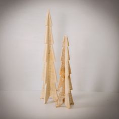 two wooden christmas trees sitting next to each other