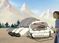 an animated character laying on the ground next to another character with mountains in the background