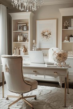 a white desk with a laptop computer on top of it and a chandelier hanging from the ceiling