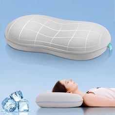 a woman laying on top of an inflatable pillow next to ice cubes