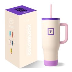 a purple and white coffee cup next to a box