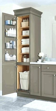 a bathroom with gray cabinets and white towels