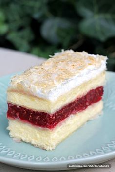 a piece of cake sitting on top of a blue plate next to a green bush