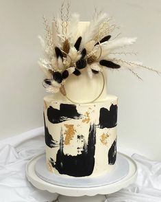 a black and white cake with feathers on top