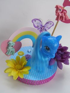 there is a toy pony with flowers and butterflies on the top of it's head