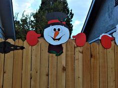 a wooden fence with a snowman on it