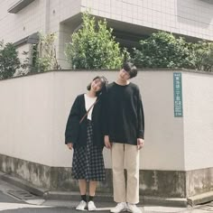 two people standing in front of a building