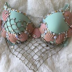 a pair of pink and blue bras with pearls on them