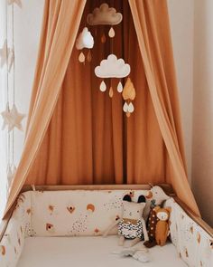 a baby crib with curtains and stuffed animals