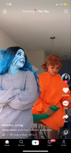 two women with blue hair are standing together