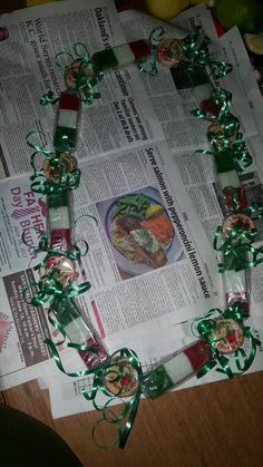 the newspaper is laying on top of the table with green ribbon and decorations around it