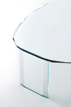 an oval glass table on white background with no one around it or someone else to the side