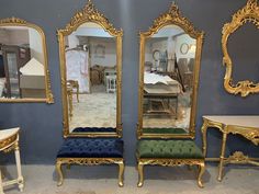 there are three mirrors and two benches in the room, one is blue with gold trim