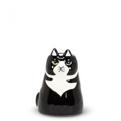 a black and white cat figurine with yellow eyes