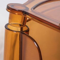 a close up view of an orange glass container