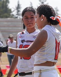 two female football players standing next to each other