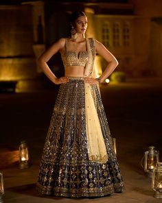 This lehenga set features all over mirror work and is paired with a fully embroidered modern cut blouse and a matching tissue organza dupatta.From Seema Gujral’s Noori collection. DELIVERY TIMEPlease allow 8-12 weeks for your outfit to arrive. FABRIC DETAILSRaw Silk. Professional cleaning only. Navy Mirror, Navy Blue Lehenga, Seema Gujral, Gold Lehenga, Mirror Work Lehenga, Cut Blouse, Work Lehenga, Blue Lehenga, Traditional Embroidery