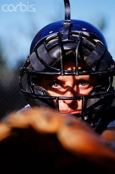 a person wearing a helmet and holding a baseball bat