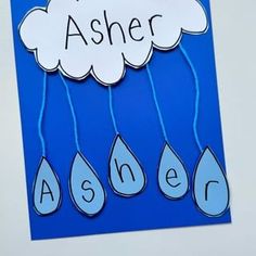 a paper cutout with the words asker and rain drops