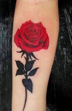 a red rose tattoo on the arm