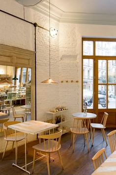 the interior of a restaurant with tables and chairs