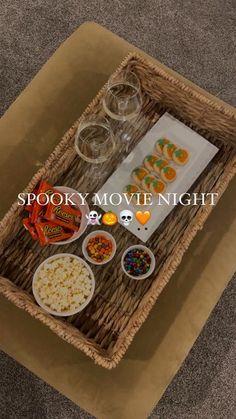 a tray with snacks and drinks on it that says spooky movie night in the middle