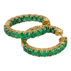 This is part of Chairish’s Fine Jewelry assortment.  Beautiful emeralds set in 18k gold. These earrings will add the perfect amount of pop and sophistication to any outfit.  18K Gold; ; 5.1 Ct Emeralds; 1 inch diameter