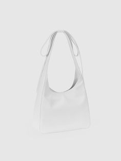 ALKI ALKA, short for Architecture Archive, incorporates the structural design of objects into its creations, adhering to the modernist philosophy of Less Is More. - Softly curved upper silhouette- Made of smooth and glossy leather- Long ribbon drop embellished shoulder strap- Hidden magnetic closure at the opening- Zipper pocket at the interior Minimalist White Shoulder Bag For Evening, Minimalist White Bag For Formal Occasions, White Minimalist Bags For Formal Occasions, Minimalist White Bags For Formal Occasions, White Minimalist Formal Bag, Minimalist White Formal Bags, Modern White Shoulder Bag With Adjustable Strap, Modern White Shoulder Bag, Versatile White Formal Shoulder Bag