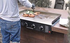 a man grilling food on an outdoor grill