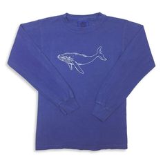 A simple Humpback Whale is hand screened in white on a bright blue youth long sleeve, pigment dyed t-shirt by Comfort Colors. This shirt is pre-shrunk, 100% cotton, 5.4-ounce children's t-shirt with ribbed collar and set-in sleeves. Shoulder to shoulder taping. Double-needle stitching on neck, sleeve, and bottom hem. All shirts fit true to size. If your child's size falls between one of these {i.e. 5} we suggest ordering up. Blue Soft-washed Long Sleeve T-shirt, Acid Wash Long Sleeve Cotton T-shirt, Casual Blue Pre-washed T-shirt, Spring Break Beach, Humpback Whale, Beach Days, Tgif, Spring Break, Bright Blue