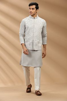 Top Details Color- Grey, Fabric - Soft Suiting Fabric With Embroidered Bottom Details Color- Off White, Fabric - Dhupion Silk, Style - Aligadi Pajama Package Include :INCLUDES 1 BANDI,1 KURTA,1 ALIGADI. Turban ,Mojari And Other Accessories Are Not Sold Along With The Dress. CARE: DRY CLEAN ONLY Additional Information : - As This Sherwani/Waistcoat/Kurta Are Made As Per Orders So It Is Strictly Not Acceptable Once Get Delivered .So Kindly Choose Body Fit Size . Also We Keep 2 Inches Extra Margin Festive Designer Nehru Jacket With Chikankari Embroidery, Sleeveless Nehru Jacket With Resham Embroidery For Eid, Sleeveless Cutdana Kurta For Eid, Festive Designer Nehru Jacket With Stand Collar, Traditional Sleeveless Bandhgala With Chikankari Embroidery, Bandhgala With Chikankari Embroidery For Eid, Eid Bandhgala With Chikankari Embroidery And Stand Collar, Sleeveless Nehru Jacket With Chikankari For Diwali, Sleeveless Nehru Jacket With Chikankari Embroidery For Diwali