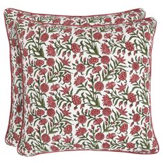 two red and white pillows with flowers on them