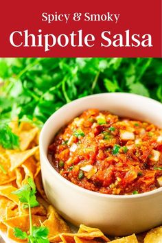 spicy and smoky chipotle salsa in a white bowl surrounded by tortilla chips