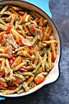 a blue pot filled with pasta and meat