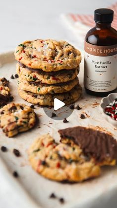 chocolate chip cookies on a baking sheet next to a bottle of syrup