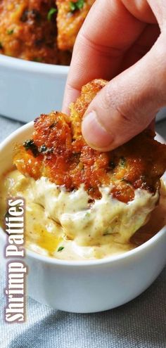 a person dipping some food into a bowl