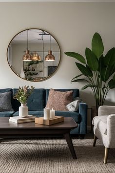 a living room filled with furniture and a large mirror on the wall above it's coffee table