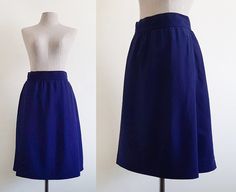 "Vintage Navy Blue Wool Skirt - Label : YVES SAINT LAURENT  - Wool fabric - Invisible nylon zipper on the back - Lining - Made in France The skirt has a small flaw. Please see the two last photos. Measurements : Waist : 26\" Hips : 42\" Total length : 24\" Our items are vintage clothing that will be cleaned so you can be confident in the quality. We carefully inspect each garment to make sure that you get the most accurate and informed description possible. We do our best to state any imperfecti Blue Long Wrap Skirt, Blue Fitted Long Wrap Skirt, Fitted Long Blue Wrap Skirt, Blue Lined Vintage Skirt, Vintage Blue Skirt For Work, Vintage Blue Lined Skirt, Vintage Blue Full Skirt, Blue Fitted Lined Wrap Skirt, Fitted Blue Flared Wrap Skirt