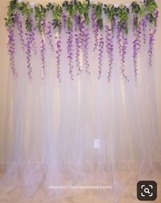 purple flowers are growing on the sheer curtain