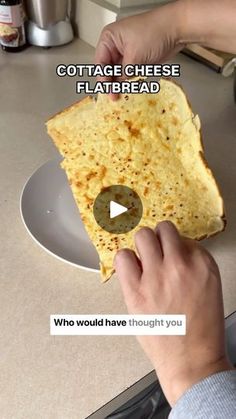 someone is holding up a piece of flatbread on a plate with the caption cottage cheese flatbread who would have thought you