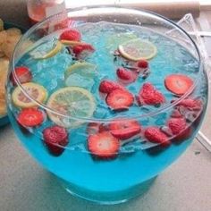 a blue bowl filled with fruit and ice