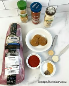 ingredients to make an italian meat sandwich laid out on a counter top with bread, spices and seasonings