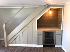 an empty room with stairs leading up to the top floor and built - in shelves