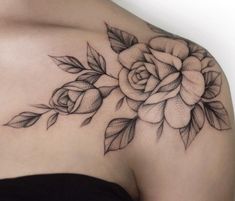 a black and white rose tattoo on the shoulder