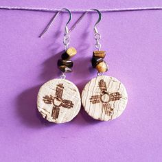 the earrings are made out of wood and have crosses on them, along with beads