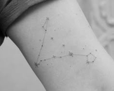 a woman's arm with a star tattoo on it