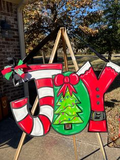 a wooden sign with a christmas decoration on it