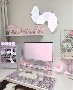 a white desk topped with a computer monitor next to a shelf filled with stuffed animals